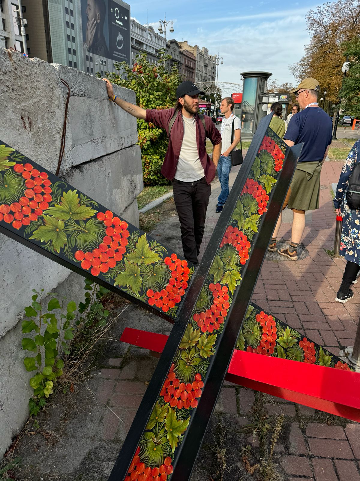 Anti-tank hedgehogs painted with Ukrainian folk-art florals on a Kyiv street
