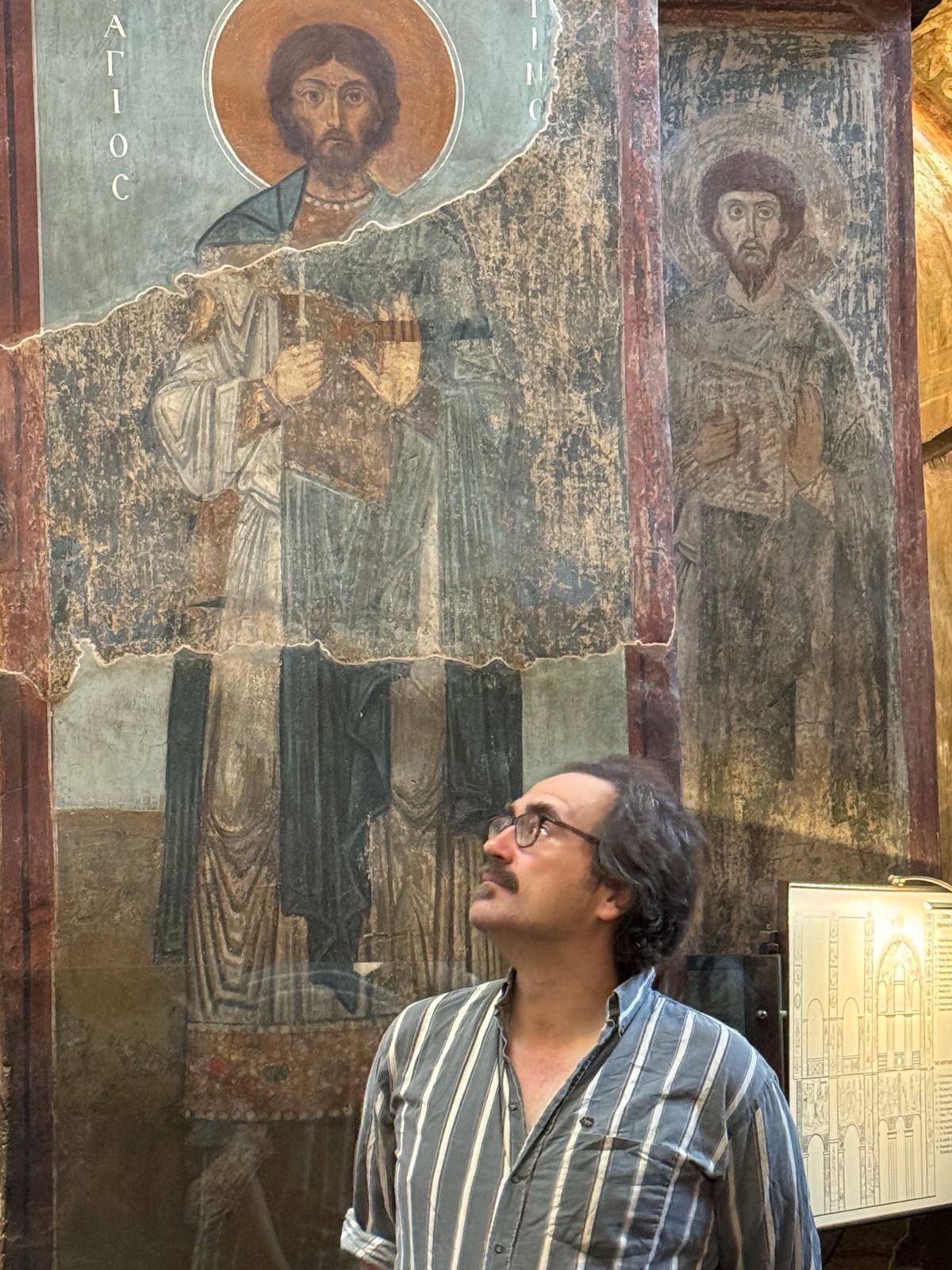 A participant gazes up at the ancient saint frescoes of St Sophia Cathedral