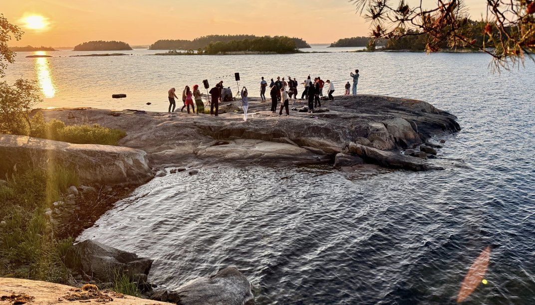 Dancing on the granite rocks by the sea at sunset